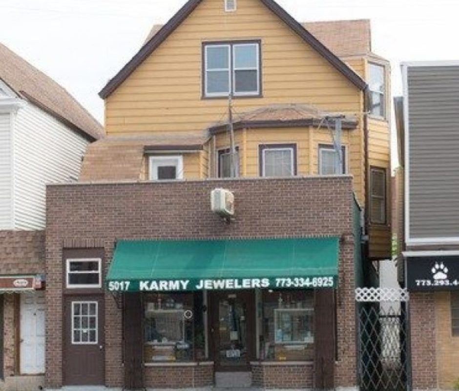 A building with a green awning on the front of it.