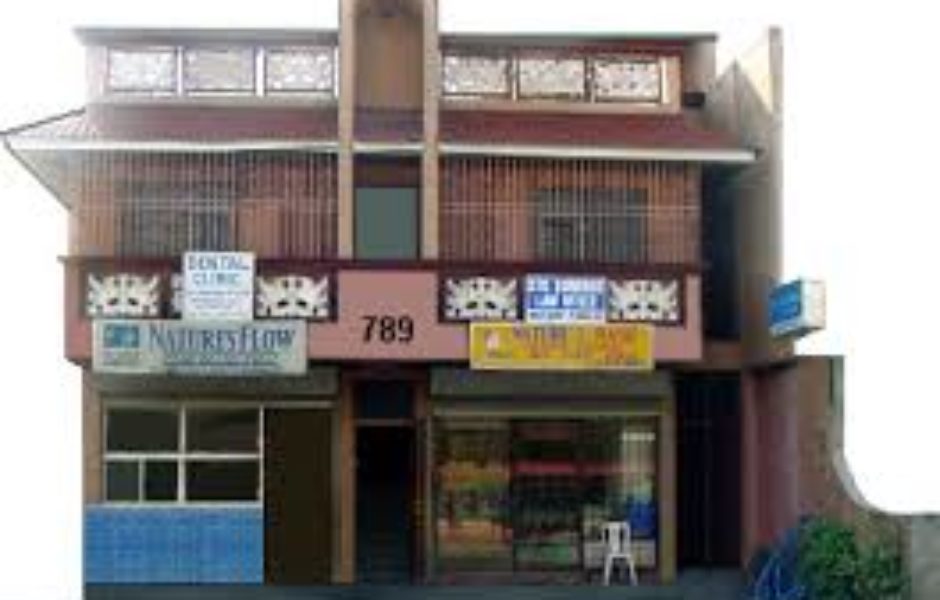 A building with many windows and signs on the front.