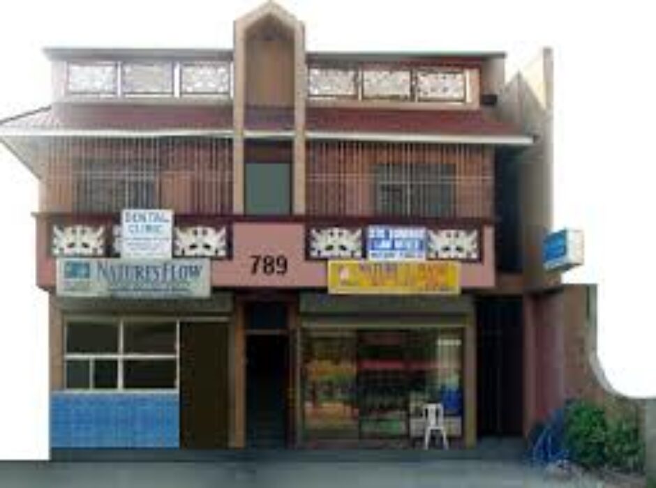 A building with many windows and signs on the front.