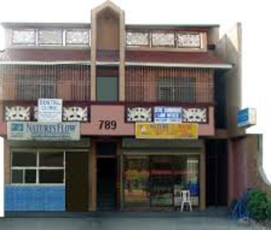 A building with many windows and signs on the front.