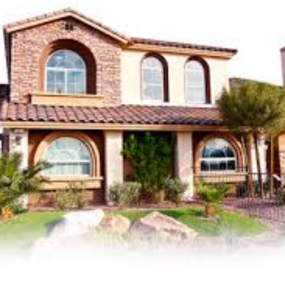 A house with two windows and a large lawn.