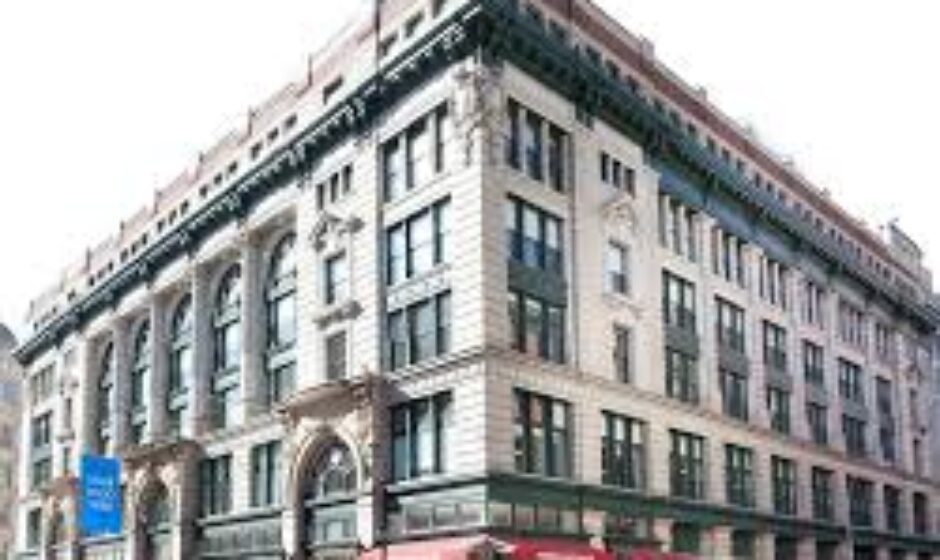 A large building with many windows and a red awning.