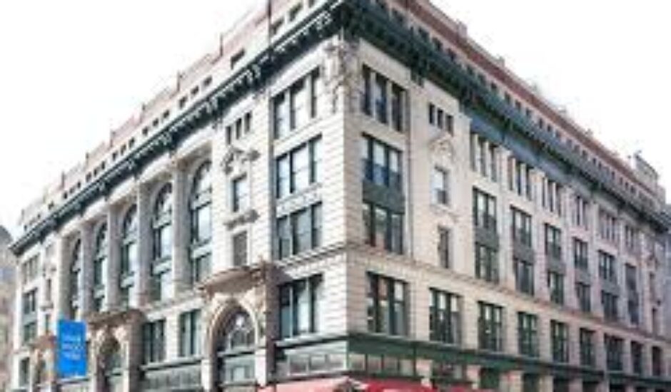 A large building with many windows and a red awning.