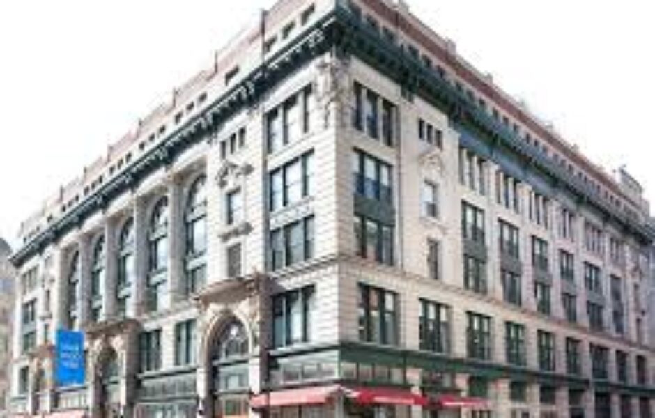 A large building with many windows and a red awning.