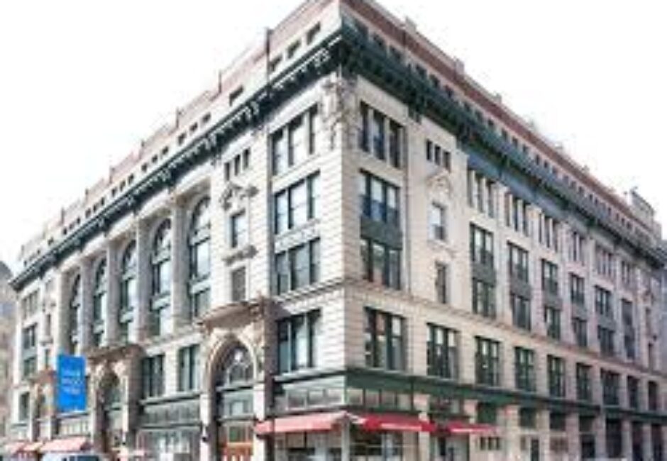A large building with many windows and a red awning.