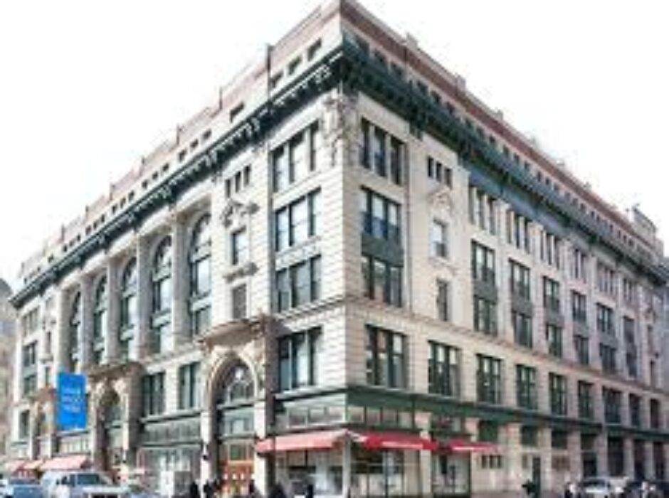 A large building with many windows and a red awning.