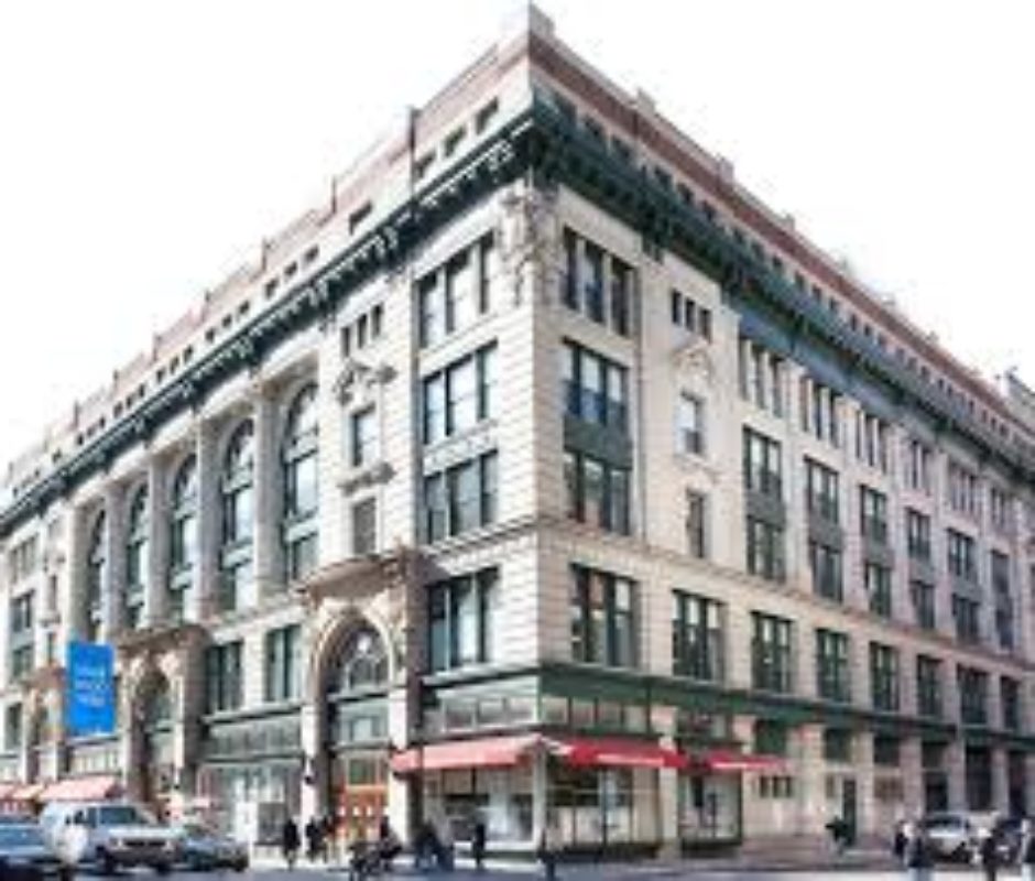 A large building with many windows and a red awning.