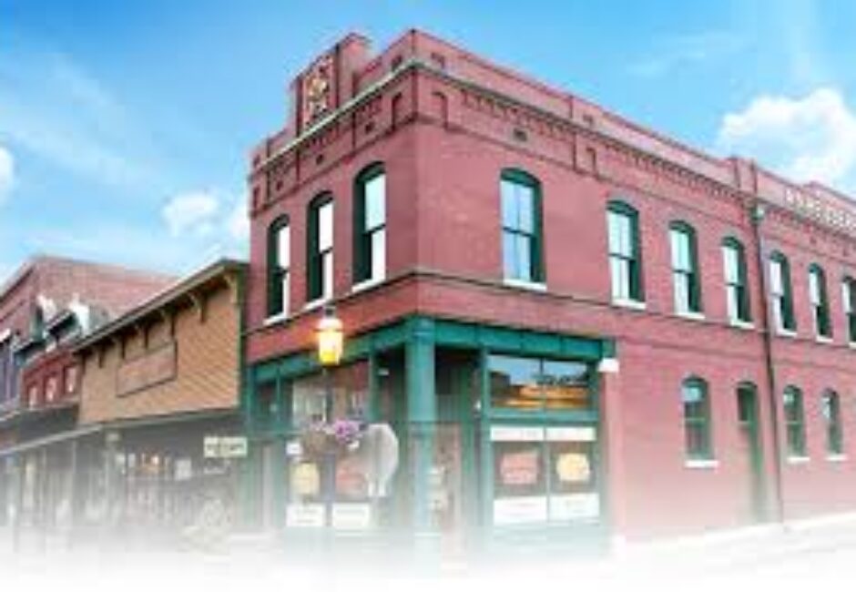 A red building with green trim and windows.