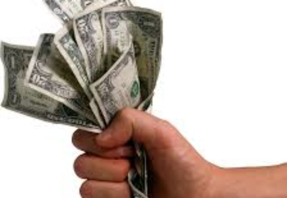 A hand holding money in each other 's hands.