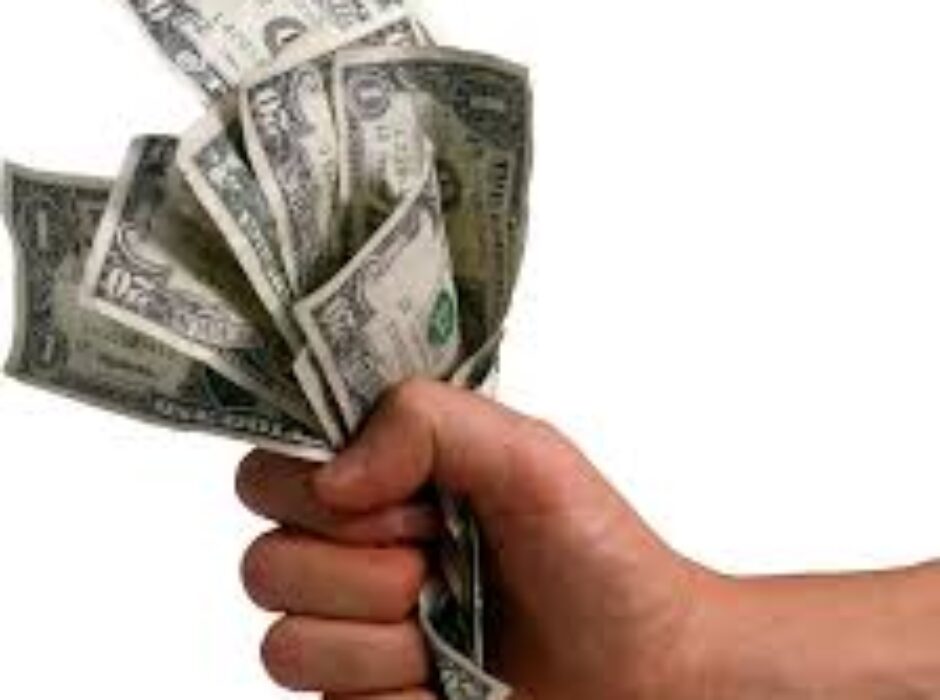 A hand holding money in each other 's hands.