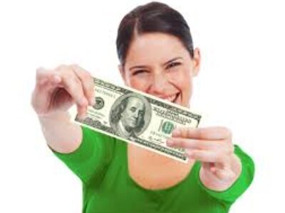 A woman holding up a $ 1 0 0 bill in front of her face.