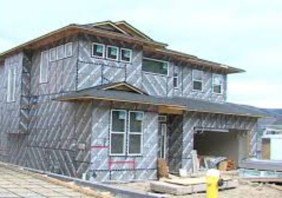 A house under construction with insulation on the outside.