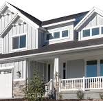 A large white house with a porch and balcony.