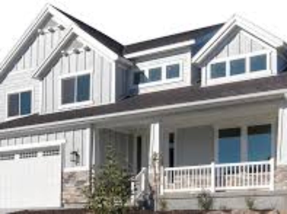 A large white house with a porch and balcony.