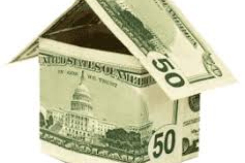 A house made of money with the capitol building in the background.