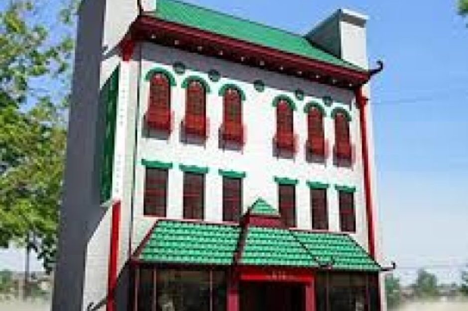 A large building with green and red trim.