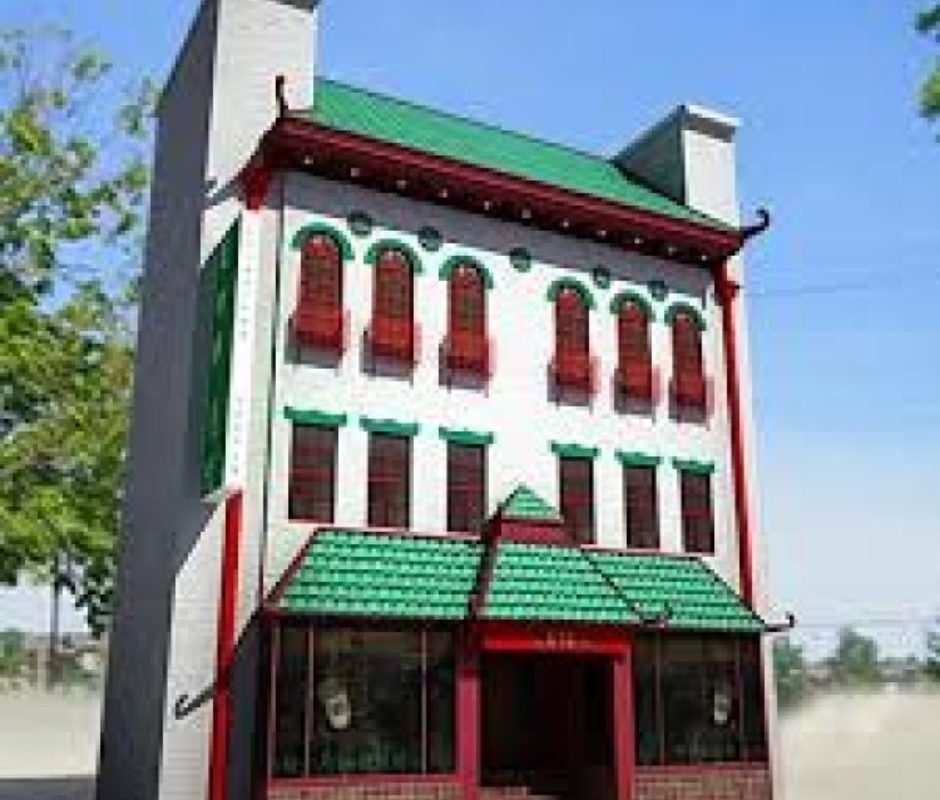 A large building with green and red trim.