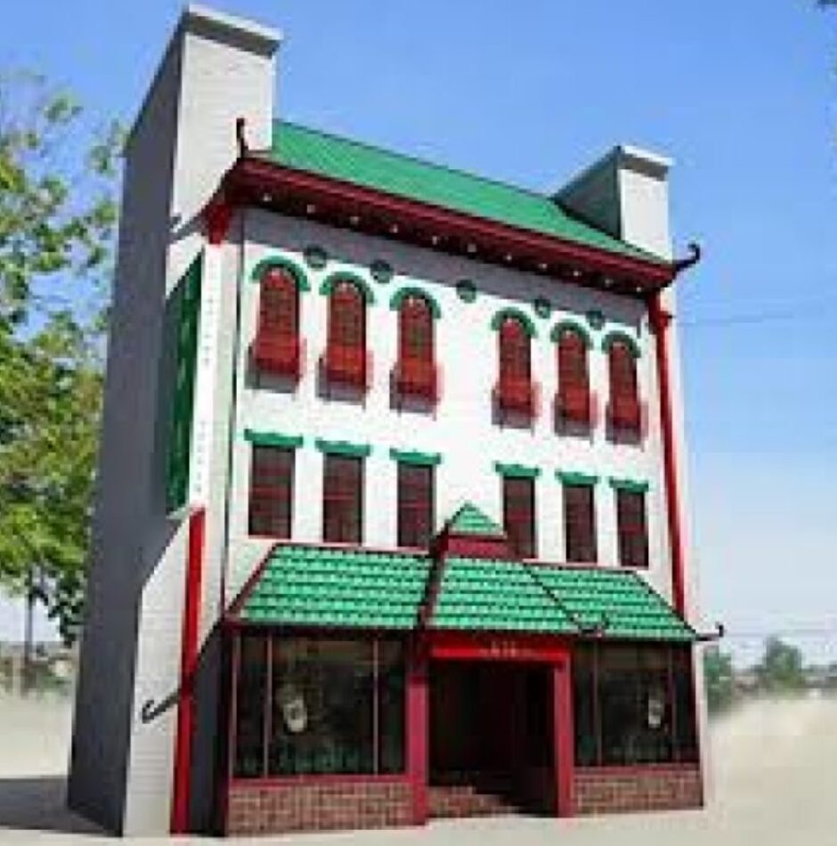 A large building with green and red trim.