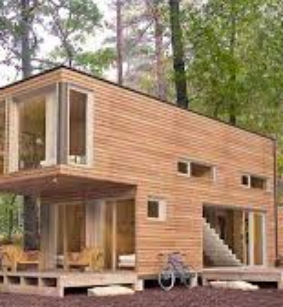 A house made out of shipping containers in the woods.