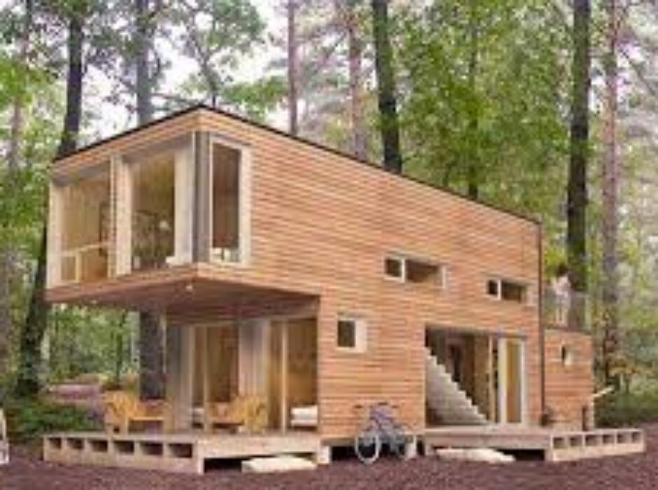 A house made out of shipping containers in the woods.