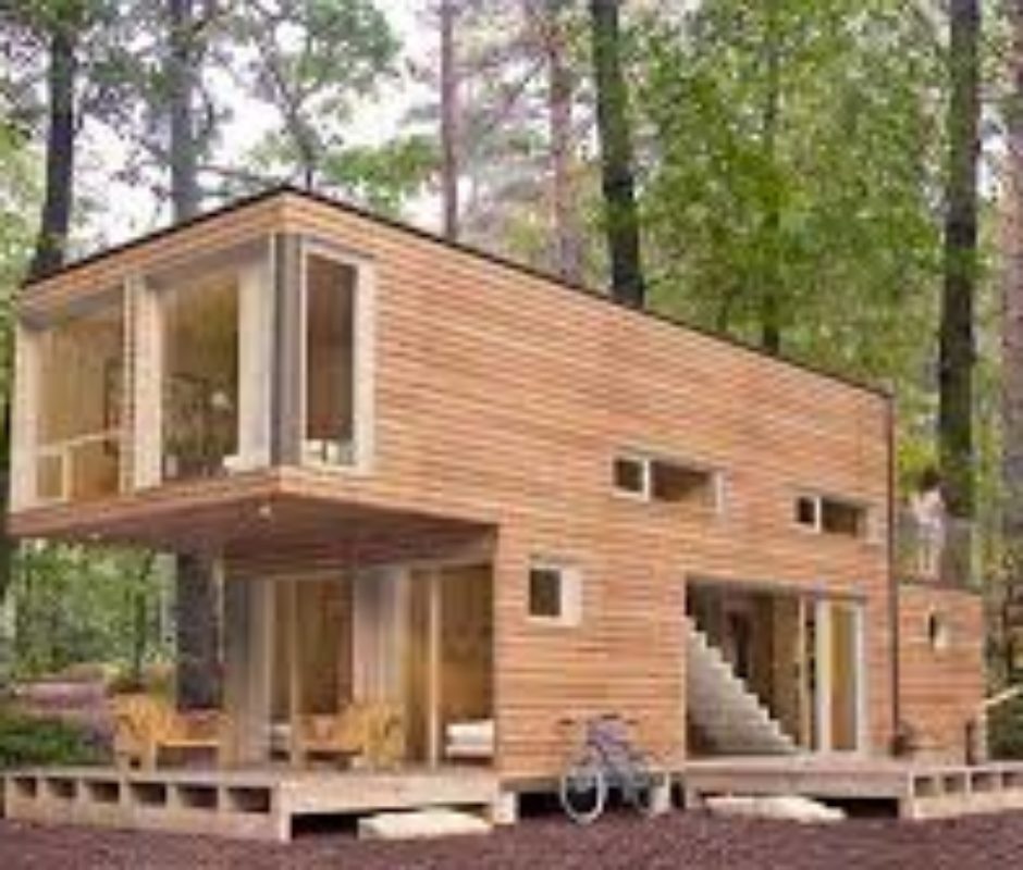 A house made out of shipping containers in the woods.