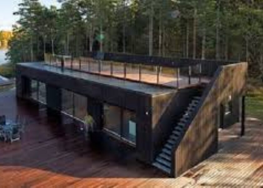 A black house with stairs going up the side.