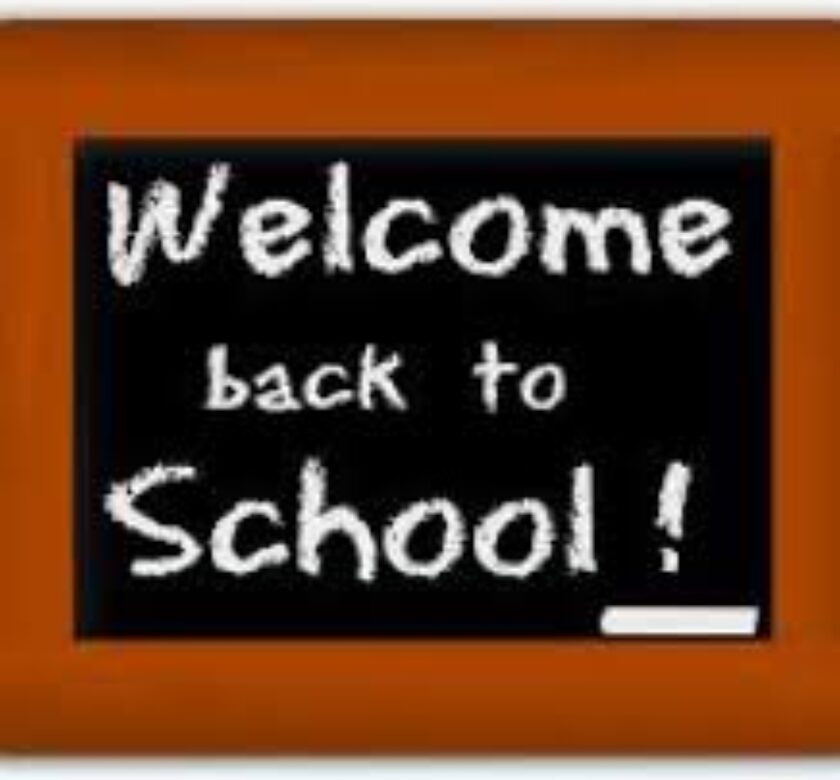 A chalkboard with the words welcome back to school written on it.