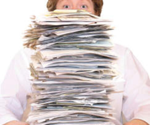 A person with a stack of papers in front of him.