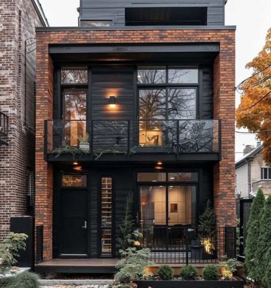 A brick house with black trim and windows.