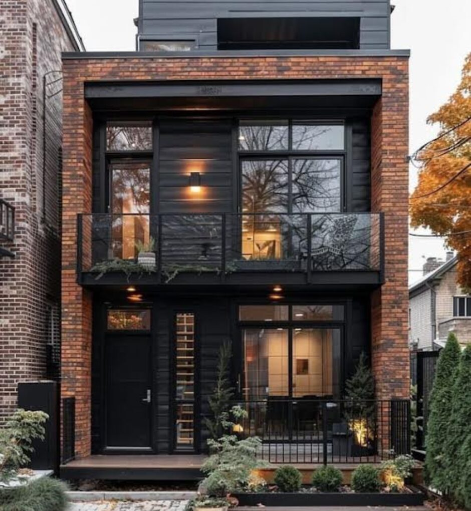 A brick house with black trim and windows.