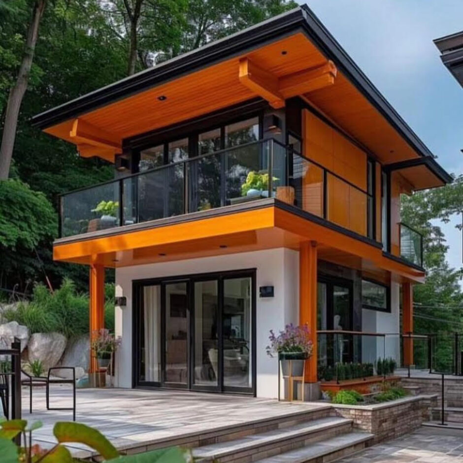 A house with a glass balcony and steps leading to the front door.