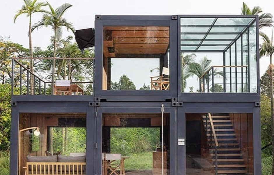 A large container house with multiple levels and a glass roof.