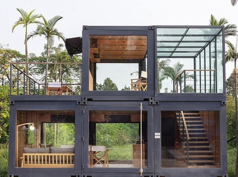 A large container house with multiple levels and a glass roof.