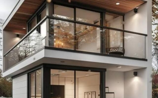 A small house with stairs and balcony in the middle